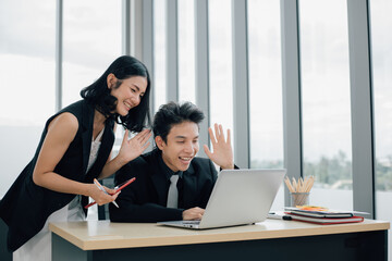 Happy business people with thumbs up on video call with laptop at office