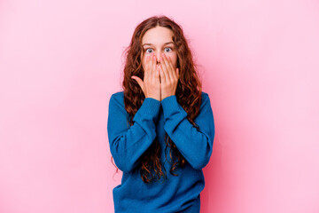 Little caucasian girl isolated on pink background shocked covering mouth with hands.