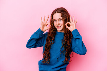 Little caucasian girl isolated on pink background cheerful and confident showing ok gesture.