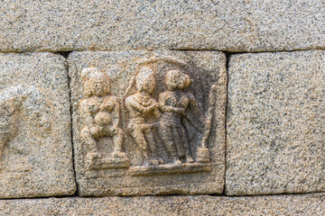 Chitradurga, Karnataka, India - November 10, 2013: Fort or Elusuttina Kote. Small erotic sculpture on main entrance gate wall, shows woman exposing herself and couple engaging in sex.