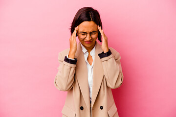 Young business mixed race woman isolated on pink background having a head ache, touching front of the face.