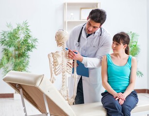 Obraz premium Doctor showing type of injury on skeleton to patient