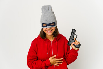 Young robber hispanic woman wearing a mask laughing and having fun.