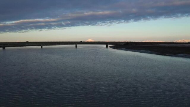 Drone footage of the Kenai River, Warren Ames Memorial Bridge, at sunset, in Alaska