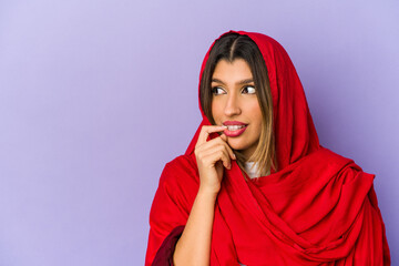 Young indian woman wearing a hijab isolated relaxed thinking about something looking at a copy space.