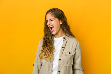 Young caucasian woman shouting very angry, rage concept, frustrated.