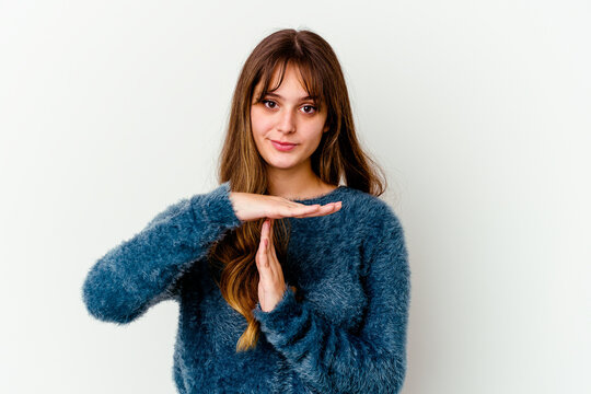 Young caucasian cute woman isolated on white background showing a timeout gesture.