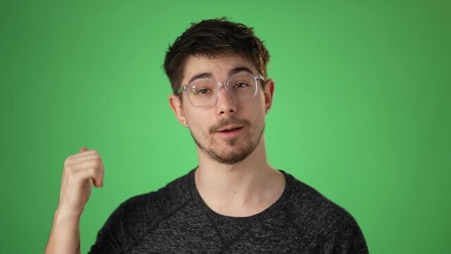 Smiling Young Hip Man Having A Video Chat, As Seen From The Point Of View Of A Computer Screen. Isolated On Green Screen Chroma Key. Concept Remote Video Chat With Friends Family.