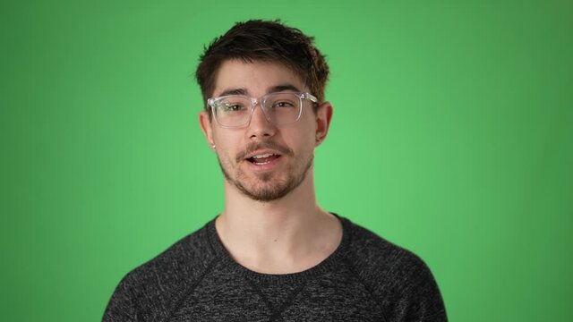 Happy young hip man having a video chat, as seen from the point of view of a computer screen. Isolated on green screen chroma key. Concept remote learning.