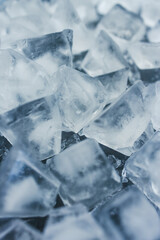 Obraz premium close-up of ice cubes in freezer tray with cold blue tones