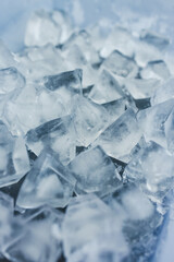 close-up of ice cubes in freezer tray with cold blue tones