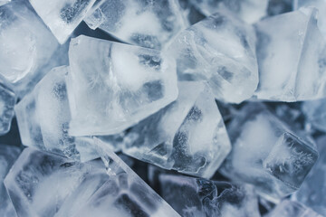 close-up of ice cubes in freezer tray with cold blue tones