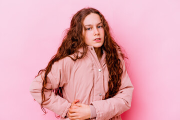 Little caucasian girl isolated on pink background having a liver pain, stomach ache.