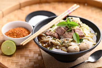 Rice noodle soup with pork, pork ball and vegetables in a bowl, Thai noodles soup