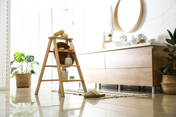 Dispensers and different toiletries on decorative ladder in bathroom. Idea for interior design