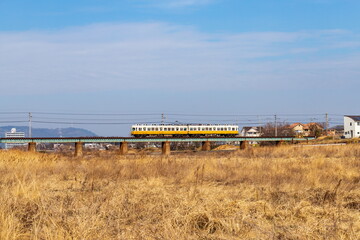Train running on a railway bridge over the river , Takamatsu city, Kagawa, Shikoku, Japan