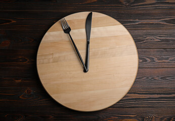 Empty board and cutlery on wooden table, top view. Diet regime