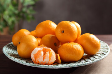 Fresh tangerines on wooden table. Citrus fruit