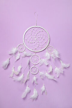 Beautiful dream catcher on violet background, top view
