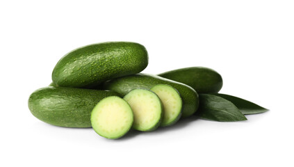 Cut and whole seedless avocados with leaves isolated on white