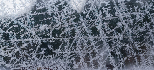 Ice pattern on glass. Abstract lines with frozen ice crystals. Concept - frostwork, frosting.