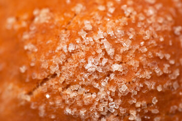 sugar crystals on a bun, homemade baking close-up, use as a background or texture