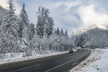 Cars carefully descent on US 2 in the Washington State Cascade Mountains after a snow storm