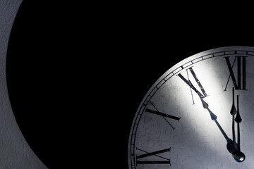 Vintage wall clock showing five minutes to midnight as a symbol for time running out