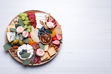 Fototapeta na wymiar Assorted appetizer served on white wooden table, top view. Space for text