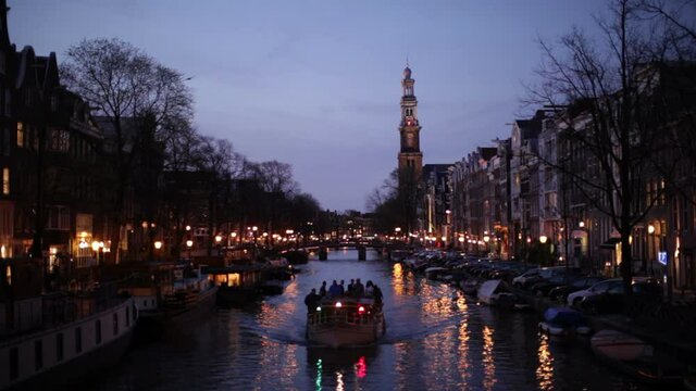 Amsterdam canal twilight lights and tour boat