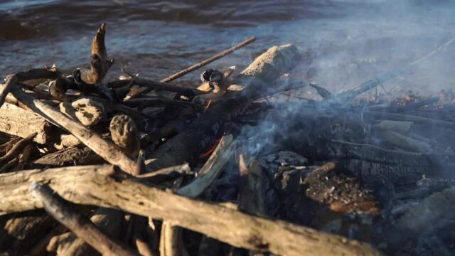 burning fire on the river bank