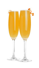 Fresh alcoholic Mimosa cocktails decorated with orange peels on white background