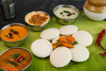 Many Idli idly sambar coconut chutney , tomato chutney serving breakfast vegetarian food South...