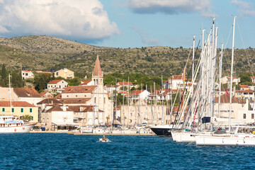 Naklejka premium Croatia, Brac, Milna. Fisherman dwarfed by sailboats in crowded Milna marina.