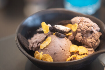 Chocolate ice cream scoops topping with corn flake and chocolate biscuits