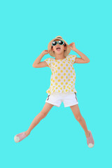 Cheerful asian little girl wearing sunglasses and straw hat jumping on cyan background isolated with clipping path. Summer and fashion concept