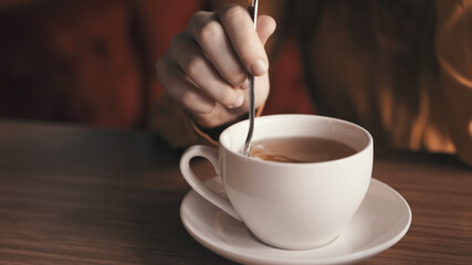Hot drink in white cup on tea party table rest