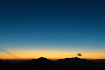 Heaven at early morning with copy space. Sunset, sunrise backdrop.Predawn clear sky with orange horizon and blue atmosphere. Smooth orange blue gradient of dawn sky.