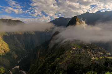 The old Inca city temple of Machu Picchu surrounded by a cloud