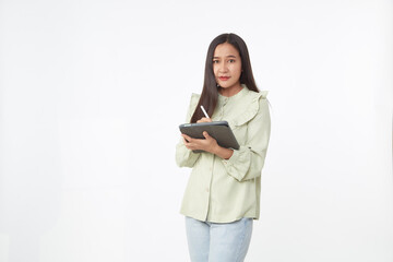 Beautiful young woman holding digital tablet and looking at camera with smile while standing. Wireless technology.