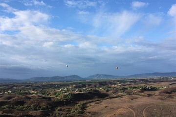 Colorful hot air balloon flying on blue sky background at Temecula in California. aerial view - 気球 カリフォルニア テメキュラ