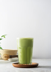 A glass of matcha tea on a concrete background with  copy space.