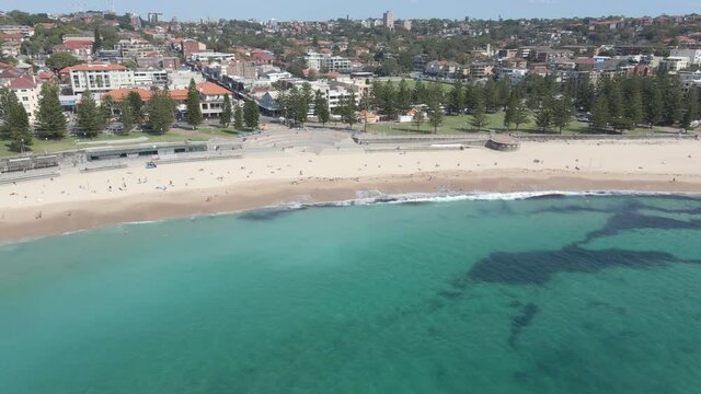 People At Coogee Beach Near Goldstein Reserve Park With Coogee City In Background - New South Wales, Australia. - Aerial Shot