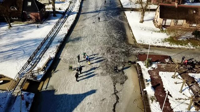 Ice skating in National park &lsquo;de weerribben&rsquo;, Overijssel, the Netherlands
Panning up shot across a canal in Kalenberg.