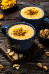 Corn Soup, Vegan cuisine. Traditional autumn corn soup. Served with corn cobs, roasted pistachios and croutons, Restaurant menu, dieting, cookbook recipe, top view
