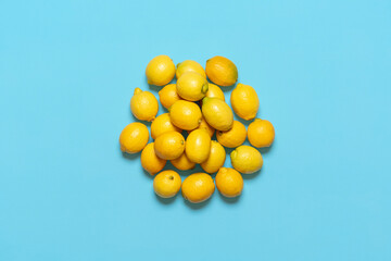 Pile of lemons isolated on a blue background. Fresh lemons above view.