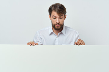 funny bearded man stands near the mockup advertising presentation