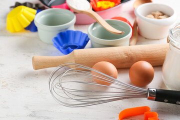 Set of kitchen utensils and ingredients for bakery on light background, closeup