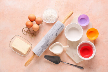 Set of kitchen utensils and ingredients for preparing bakery on color background