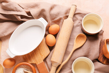 Set of kitchen utensils and ingredients for preparing bakery on color background, closeup